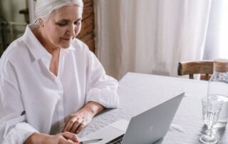 woman looking at her credit card to enter online