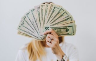 woman holding a fan of money